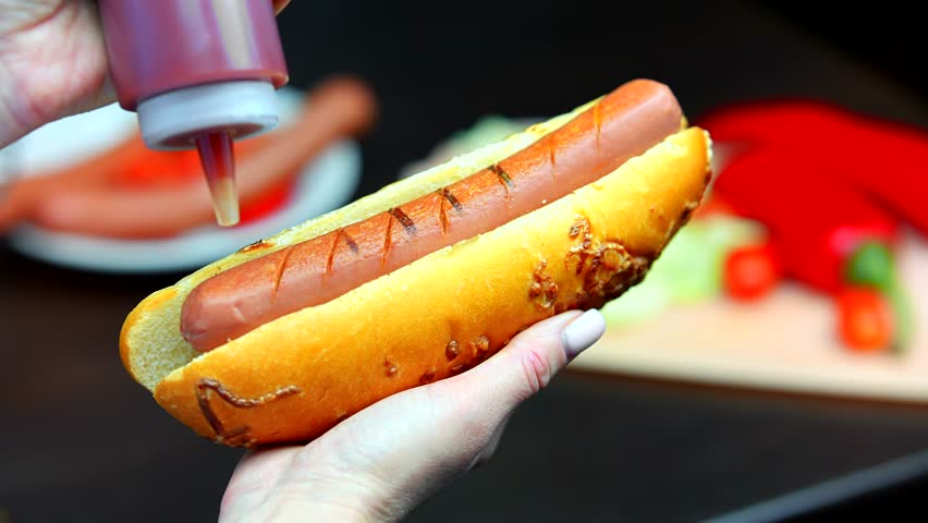 Hot Dog Served Mustard And Ketchup. American Fast Food. Tasty Hot Dog With Grilled Sausage. Appetizing Street Food. Grilled Sausage Hot dog Junk Food. Adding Ketchup And Mustard To Tasty Hot Dog Meat Royalty-Free Stock Footage #3439440217