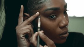 Close-Up Face of Black Latina Young Woman Applying Makeup in Front of Mirror, 20s Adult Girl of African Descent Getting Ready to Go Out - Powered by Shutterstock - Get 15% off with code: PIKWIZARD15