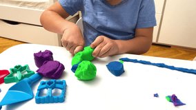 child boy playing at home,molding colored plasticine.Kid sculpts with clay stucco.Play dough.art creativity,craft at kindergarten.Development of fine motor skills.sensory education. - Powered by Shutterstock - Get 15% off with code: PIKWIZARD15