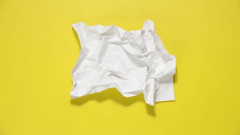 Stop motion animation of crumpled paper, stop motion animation 4k, on a yellow background. – Video có sẵn