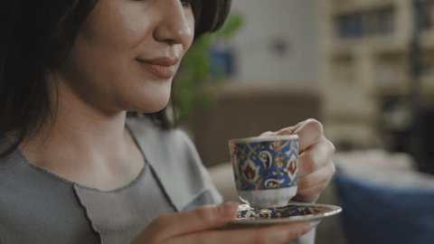 young woman drinking Turkish coffee Arkivvideo