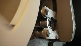 Macro working process of 8mm film projector rotating filmstrip reels. Mechanism 