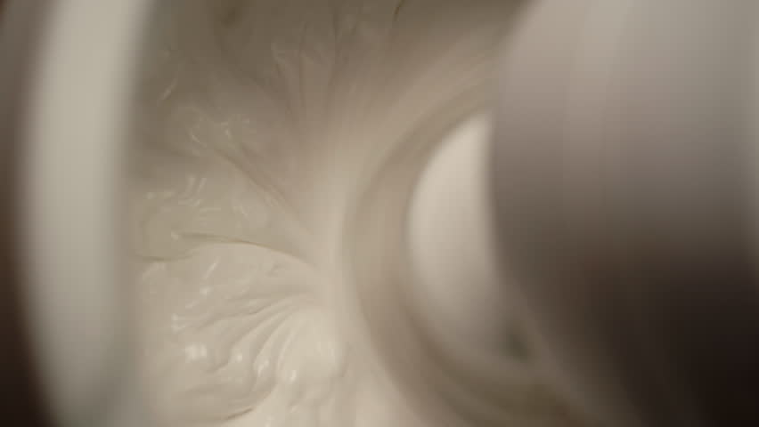 Mixing whipped cream in a stand mixer with a whisk, close-up. Whipping cream mixed with a mixer wire whisk Royalty-Free Stock Footage #3439540969