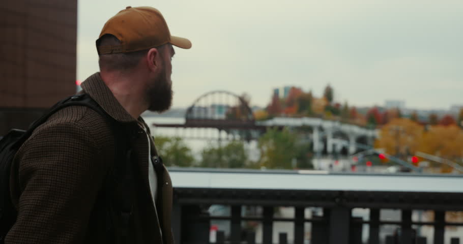 Handsome stylish bearded man walking and enjoying the view of Little Island at Hudson River park in New York.