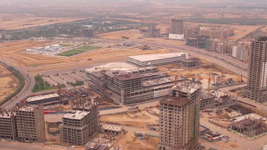Aerial Flight Over a New Construction Development Site |  Aerial View. High crane works on building site | skyscraper under construction in Bahria Town Karachi Royalty-Free Stock Footage #3439556703