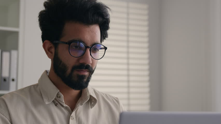 Tired overworked man Indian Arabian businessman working on laptop in glasses confused business employer taking off eyeglasses eyes problem blurry vision check eyesight eye laser correction health care Royalty-Free Stock Footage #3439602043