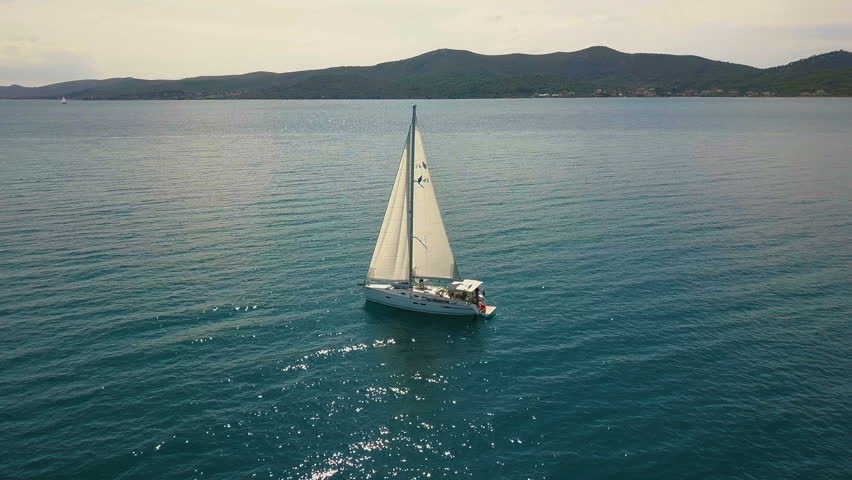 Yacht sailing on opened sea. Sailing boat. Yacht from drone. Yachting video. Yacht from above. Sailboat from drone. Sailing video. Yachting at windy day. Yacht. Sailboat. Royalty-Free Stock Footage #34396450