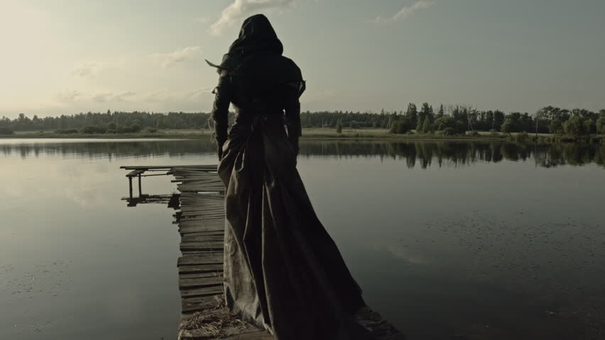 A girl in black rags walks along a rotten bridge. Apocalypse. 4k