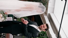vertical video happy lovers the groom lifts the veil of the bride in a white dress at the altar the newlyweds at wedding - Powered by Shutterstock - Get 15% off with code: PIKWIZARD15