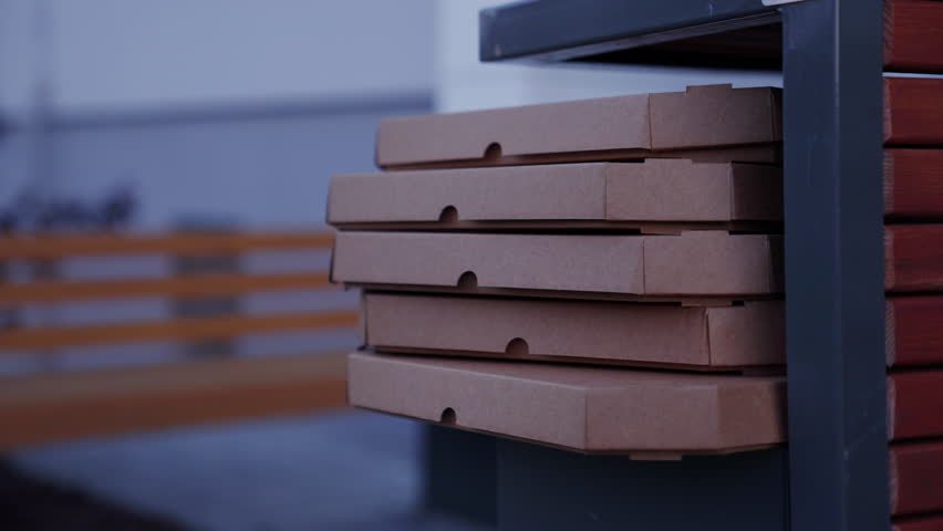 Empty pizza boxes are in the trash