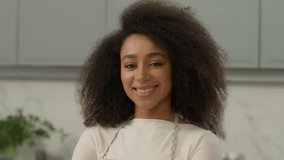 Portrait African American woman ethnic girl biracial female chef cooker baker mother housewife homeowner wife smiling posing in home modern kitchen interior wearing apron cooking food delivery cook - Powered by Shutterstock - Get 15% off with code: PIKWIZARD15