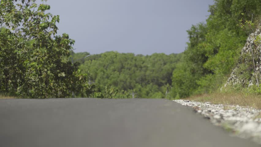 The mirage effect shimmering on a sunlit road during the day. The heat haze effect of a road at mountainous dry region