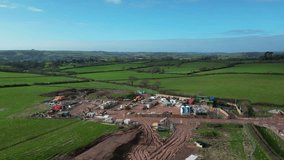 Paignton, South Devon, England: DRONE VIEWS: The drone circles a new build housing development under construction on green belt land at White Rock. Paignton is a popular UK holiday resort (Clip 11).