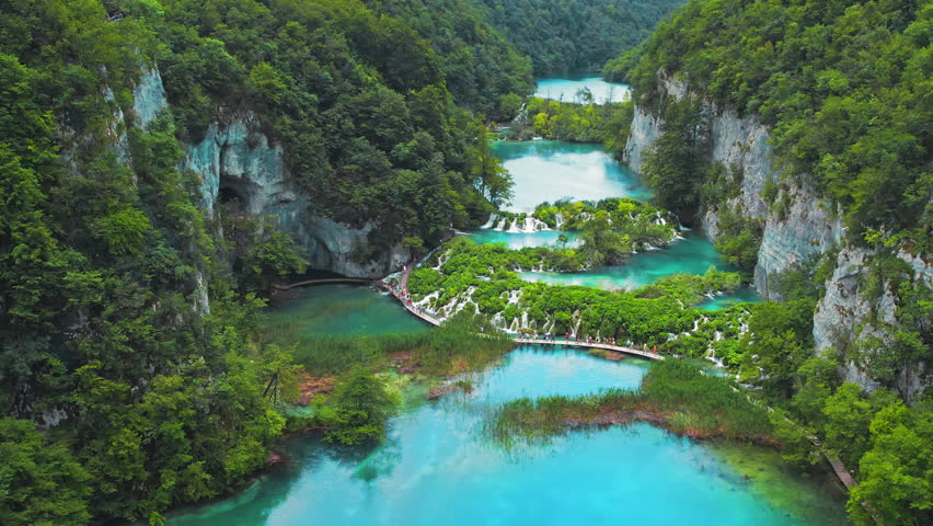 Emerald waters of Plitvice Lakes are naturally supersaturated with calcium carbonate. Largest national park in Croatia. Scenic waterfalls.