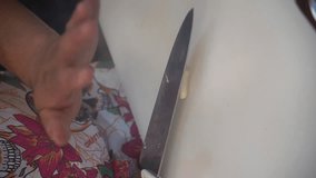 Chef uses knife to break fresh garlic and chop it, prepare for home cooking. vertical video