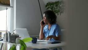 Female doctor sitting at table, reading patient test results and making call, consulting with patients. Healthcare workers having stressful job, feeling exhausted. Burnout syndrome for doctors and - Powered by Shutterstock - Get 15% off with code: PIKWIZARD15