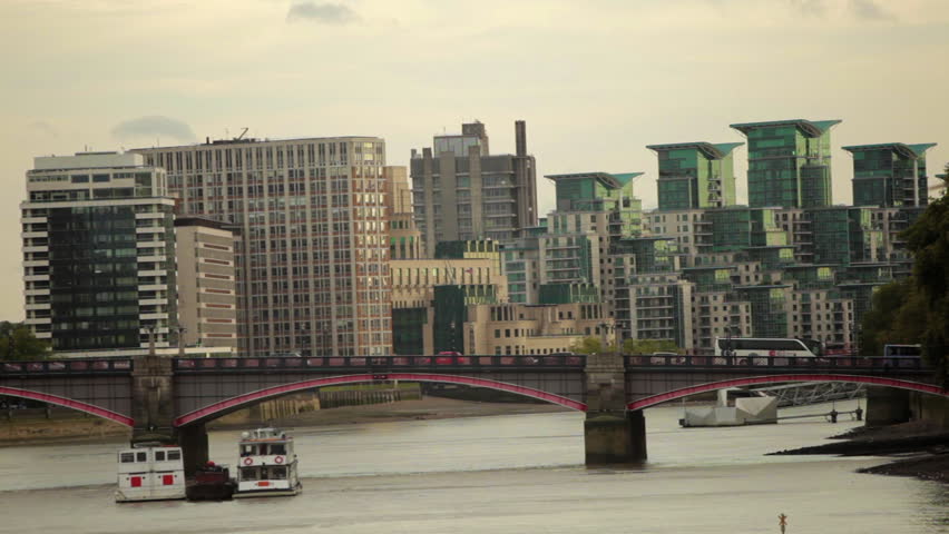 Lambeth Bridge and cars crossing it with buildings in the background in London,