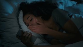 Sleepy African American woman tired girl sleep nap rest at night home dark bedroom sleeping in bed with mobile phone scrolling smartphone addict gadget read social media yawning fall asleep nighttime - Powered by Shutterstock - Get 15% off with code: PIKWIZARD15