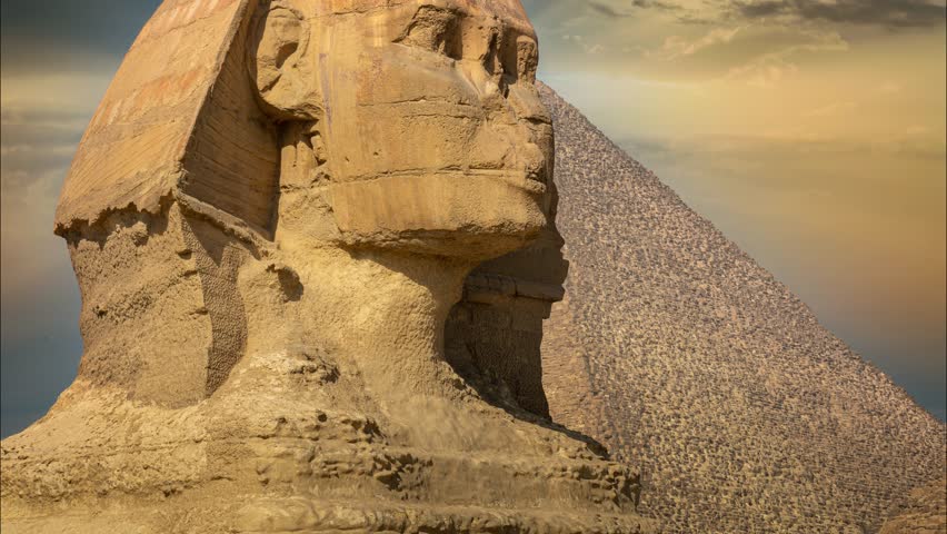 The Great Sphinx of Giza showing a side view of the head and face with the pyramid in the background.
