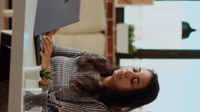 Vertical video Self employed woman sitting at computer desk, typing on laptop keyboard in personal office. Freelancing businesswoman inputting data on notebook, doing her job before deadline - Powered by Shutterstock - Get 15% off with code: PIKWIZARD15