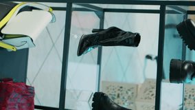 Vertical Video Empty modern clothing store filled with formal wear designs, retail shop with fashion items on hangers and racks. Shopping center boutique with trendy accessories and shoes on display - Powered by Shutterstock - Get 15% off with code: PIKWIZARD15