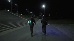Mans walking on the night street with lighting longboards - Powered by Shutterstock - Get 15% off with code: PIKWIZARD15