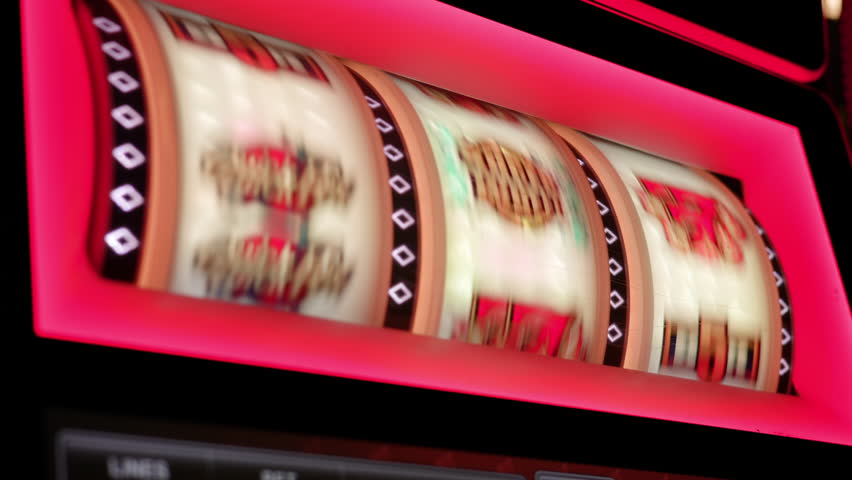Vivid close-up of spinning slot machine reels with colorful symbols, including the classic lucky seven and bar sign. Slow Motion, 4K RAW.  Royalty-Free Stock Footage #3440300929