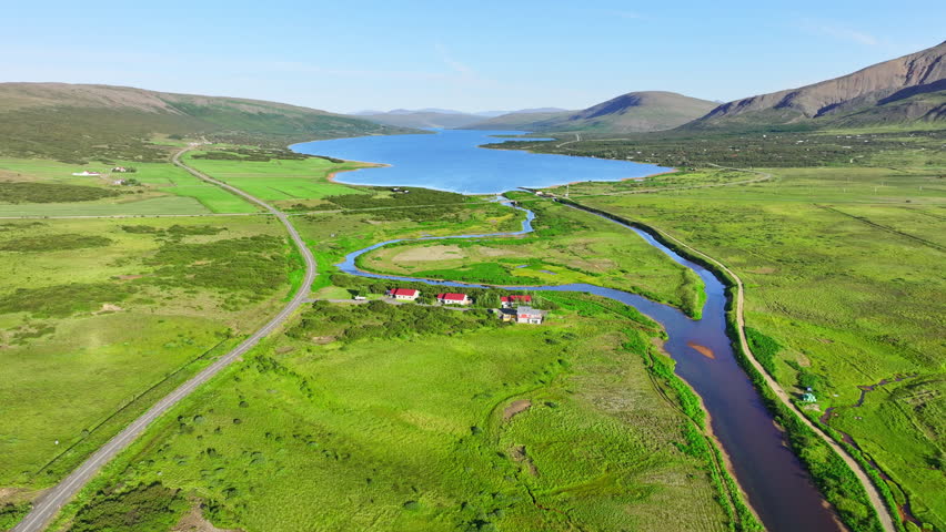 Stunning countryside in Iceland, Farmhouses in a northern country, Hilly landscape on a sunny day, Green meadows, Beautiful untouched nature aerial view