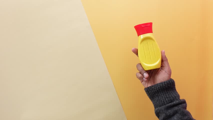 top view of holding a mustard mayonnaise container 
