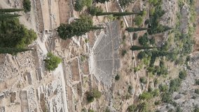 Vertical video. Delphi, Greece. Ruins of the ancient city of Delphi. Sunny weather, Summer, Aerial View
