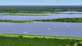 Aerial view of big sustainable electric power plant with many rows of solar photovoltaic panels for producing clean electrical energy. Renewable electricity with zero emission concept - Powered by Shutterstock - Get 15% off with code: PIKWIZARD15