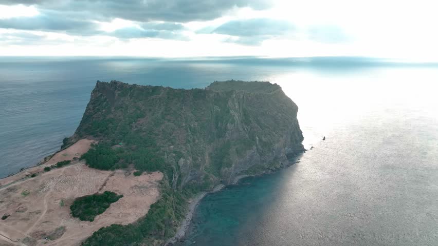Drone View of Jeju island in South Korea, Sunrise Peak in Seongsan, Yunasco, winter