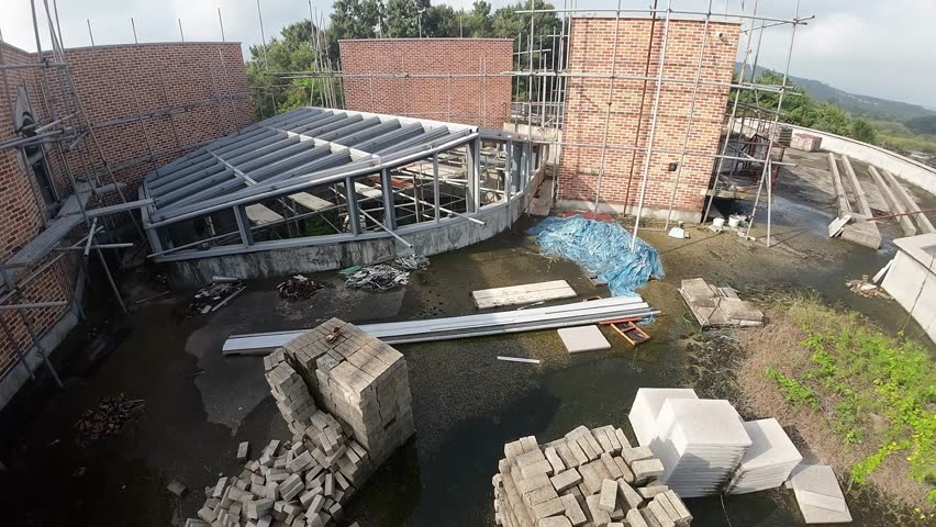 drone flying through an abandoned constuction site, roof top scaffodlings