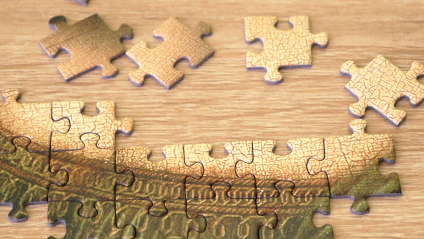 hands putting together a puzzle on wooden desk, method for collecting puzzles by sorting, closeup Royalty-Free Stock Footage #3440429487