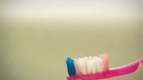 white toothpaste on brush at home. Squeezing toothpaste onto a toothbrush A dental care moment. on a white background, lifestyle oral hygiene routine
