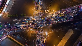 Vertical video. Aerial time-lapse of evening traffic at intersection in Ho Chi Minh City, Vietnam.