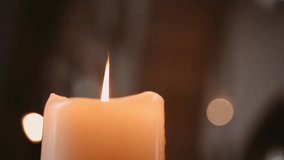 Closeup footage of candle flame in church