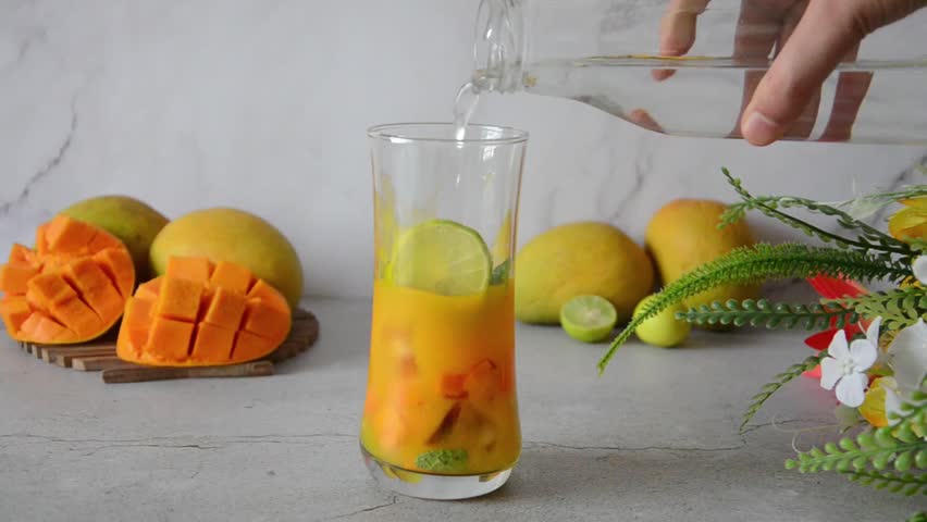 Mango Mojito Mocktail - Non-Alcoholic Mojito, Citrus Mango Mocktail, Summer Mocktail, Mocktail Party - A Tropical Twist - Refreshing Blend of Mango, Mint, and Citrus - Perfect for Summer Sipping. Royalty-Free Stock Footage #3440589529