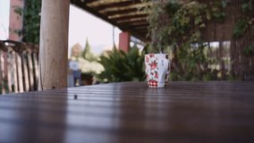 Lockdown shot of coffee cup on wooden outdoor table
