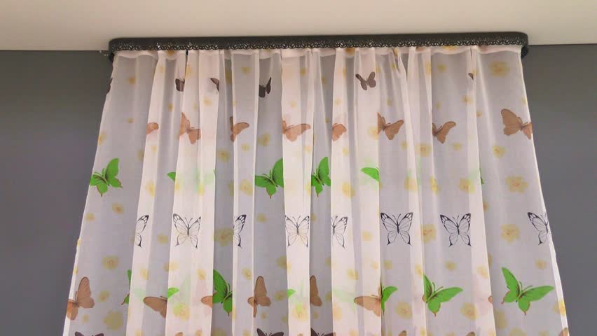 Tulle curtains with butterflies fall down in motion. The fabric is delicate and airy for a cafe showcase. Royalty-Free Stock Footage #3440625789