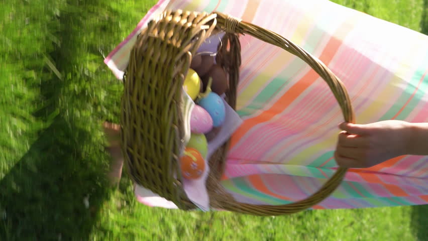A little girl having easter egg hunt in garden backyard with basket Royalty-Free Stock Footage #3440657209