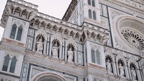 From below footage of sculptures on exterior of Florence Cathedral, Tuscany, Italy