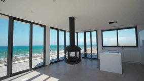 Oceanfront penthouse interior showcases modern design, panoramic sea views, floor-to-ceiling windows, upscale amenities.