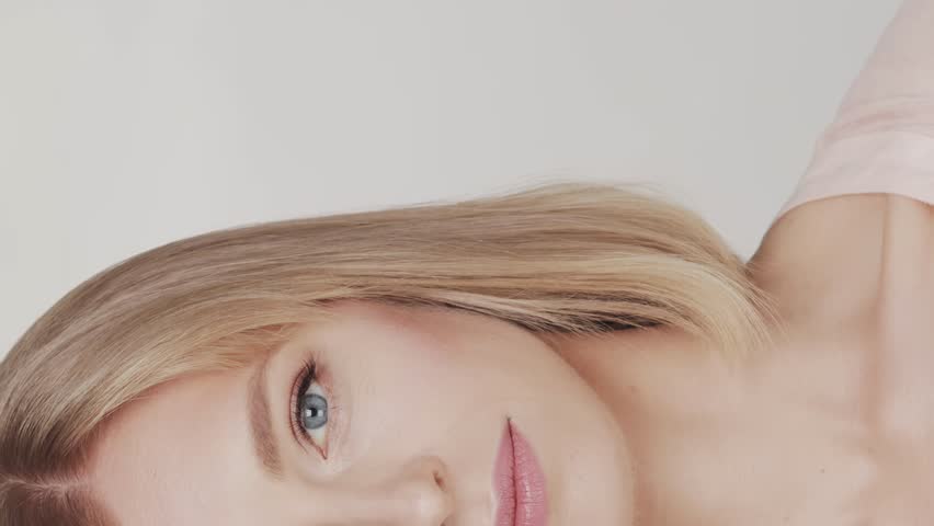 Studio portrait of young, beautiful and natural blond woman. Face lifting, cosmetics and make-up concept.