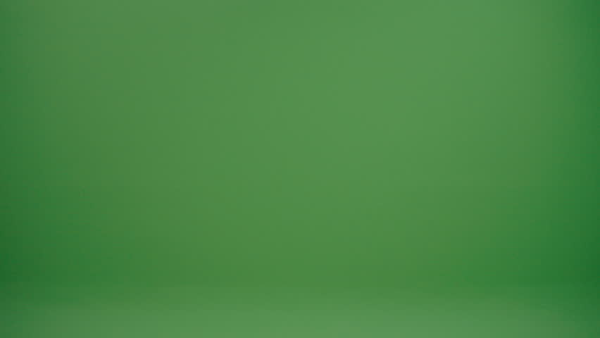 Green Screen. An Old Wizard With a Gray Beard, Dressed in a Medieval Clothing and Magic Hat, Walks With a Magic Wand in His Hand. Witchcraft and Mystery. School of Magic and Fairy Tale Concept.