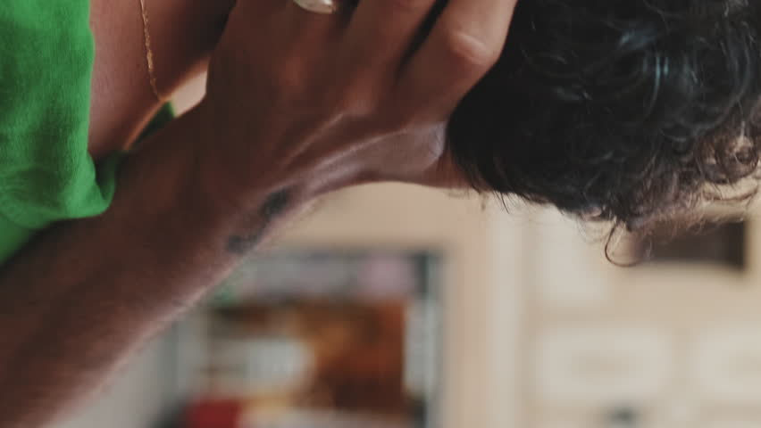 Vertical video, Close-up of gay couple in romancing standing on street of old city