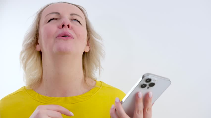pleasant emotions easing state of mind woman holding her hand on her chest raised her head up in the other hand phone pleasant news joy calm down relax stop worrying Royalty-Free Stock Footage #3440863599