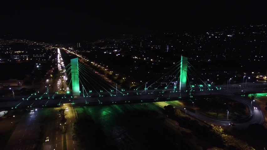 Aerial night footage over bridge and highway in Medellin City in Colombia 