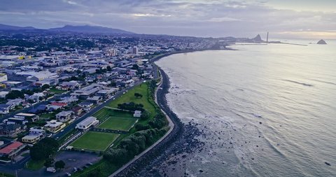 aerial: flying over the city of New Plymouth at sunset, Taranaki, New Zealand