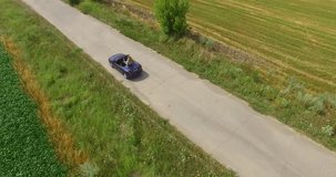 aerial view of the car traveling around in the village road with a beautiful panorama and landscape